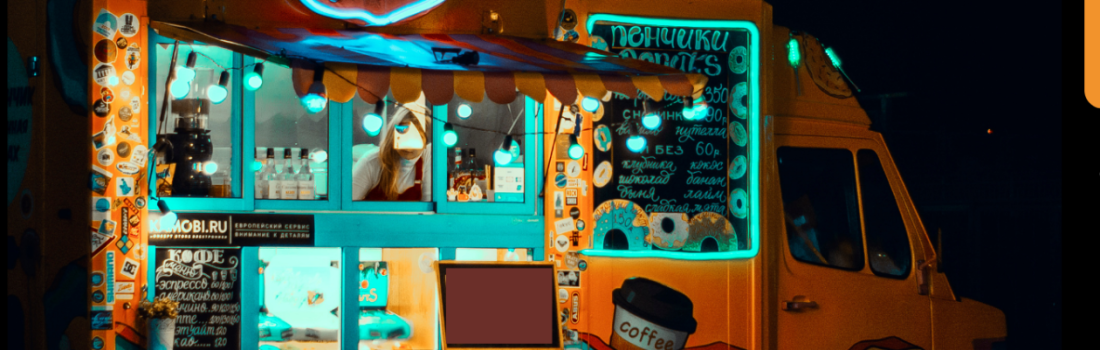 Image of a florescence yellow food truck at night with teal blue highlights around windows